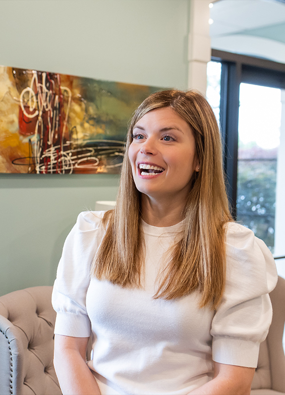 Smiling woman talking to dental office receptionist