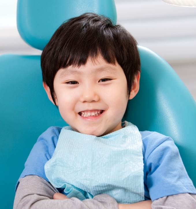 Young boy smiling in dental chair