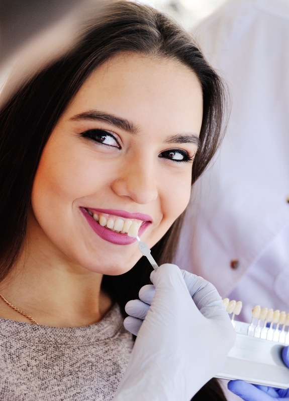 Young woman being fitted for veneers by cosmetic dentist