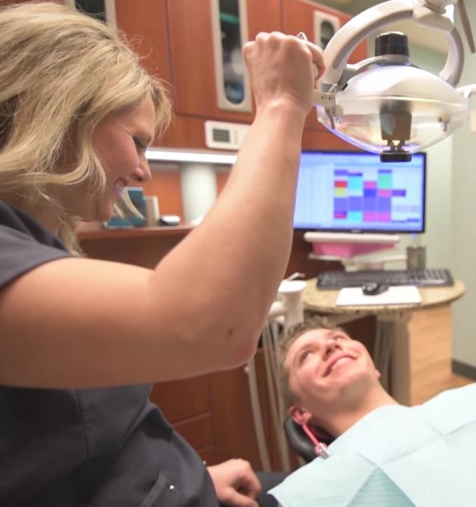 Dental team member smiling at a patient while providing dental services in Jonesboro