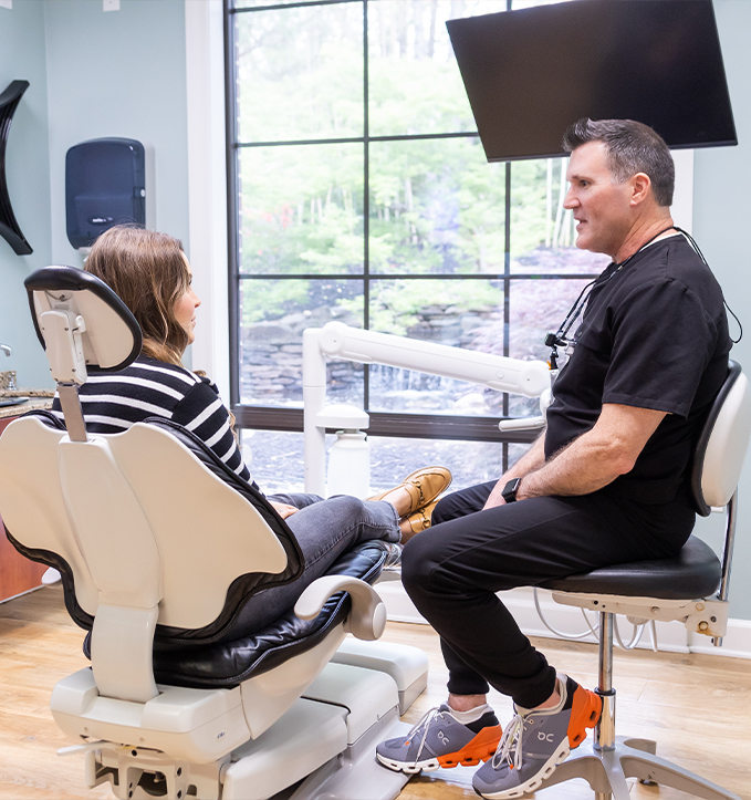 Dental team member smiling at a patient while providing dental services in Jonesboro