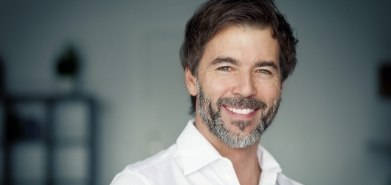 Man in white collared shirt smiling