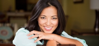 Smiling woman leaning over the back of her chair