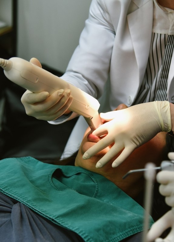 Dentist taking digital impressions of a patients teeth