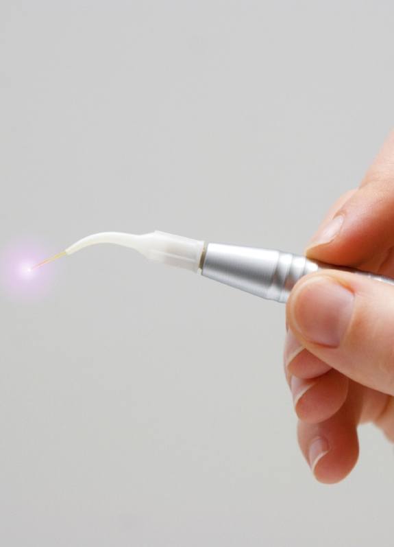Hand holding a dental laser pen device