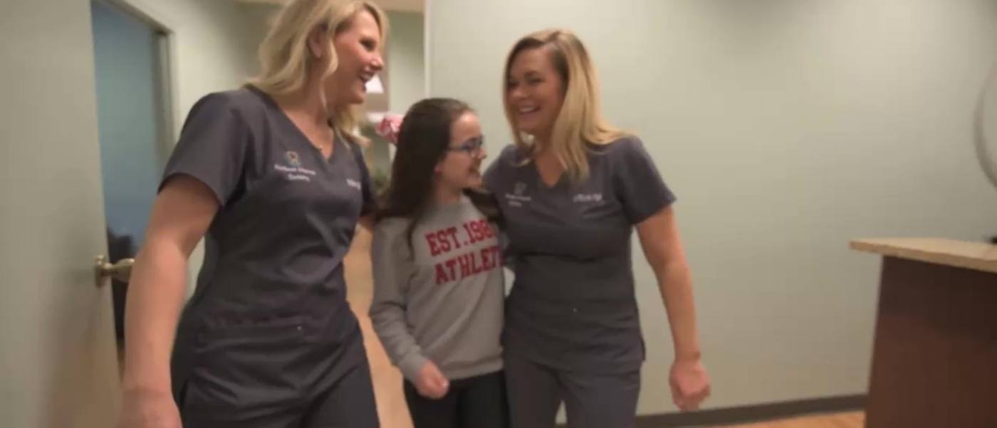 Two Jonesboro dental team members laughing with a patient