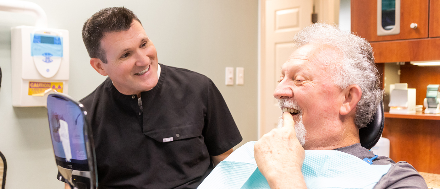 Two Jonesboro dental team members laughing with a patient