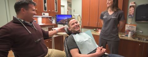 Man in dental chair laughing with his Jonesboro dentist