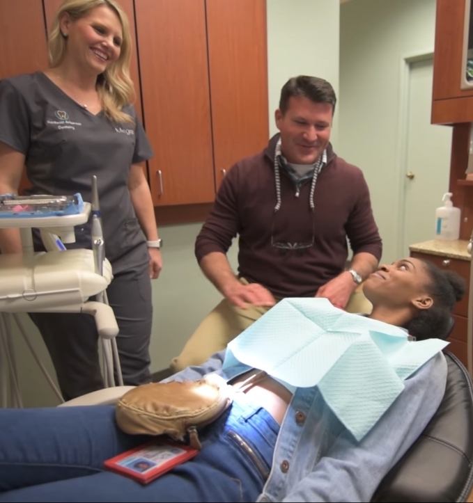 Jonesboro Arkansas dentist Doctor Joseph S Spades smiling at young woman in dental chair