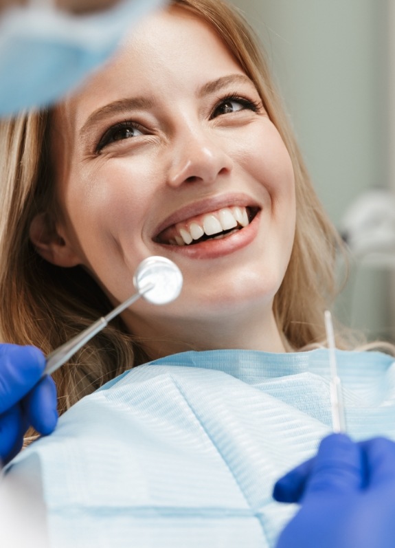 Woman smiling at her dentist during a dental checkup