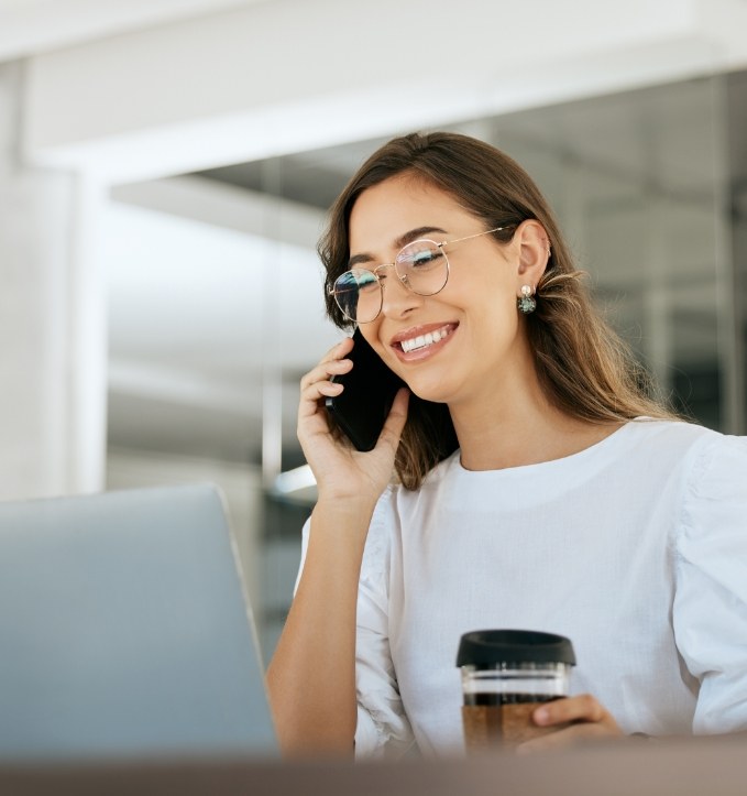 Woman talking on phone to request a dental appointment in Jonesboro