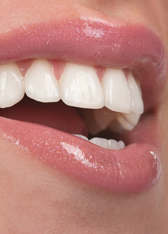 Close up of mouth with straight white teeth