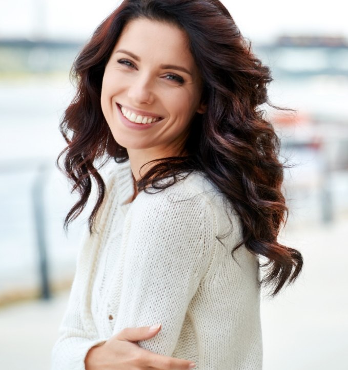 Woman in white sweater smiling